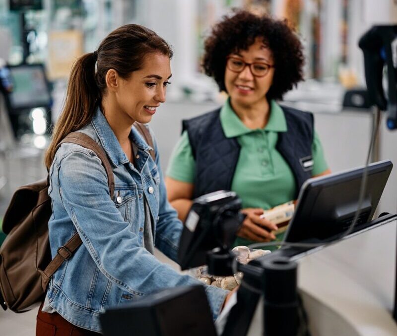 smiling-supermarket-customer-using-self-service-ti-2022-09-27-20-00-19-utc